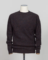 Harley of Scotland's iconic shaggy crew neck sweater in volcano. Hand-knitted using traditional Scottish techniques, this piece features a distinctive textured surface that catches light beautifully while delivering exceptional softness against the skin. The relaxed crew neck silhouette works seamlessly as a standalone layer or under tailored blazers for refined versatility.

Premium wool construction provides natural warmth and breathability across seasons. The generous shag pile creates visual depth and t