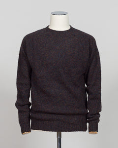 Harley of Scotland's iconic shaggy crew neck sweater in volcano. Hand-knitted using traditional Scottish techniques, this piece features a distinctive textured surface that catches light beautifully while delivering exceptional softness against the skin. The relaxed crew neck silhouette works seamlessly as a standalone layer or under tailored blazers for refined versatility.

Premium wool construction provides natural warmth and breathability across seasons. The generous shag pile creates visual depth and t