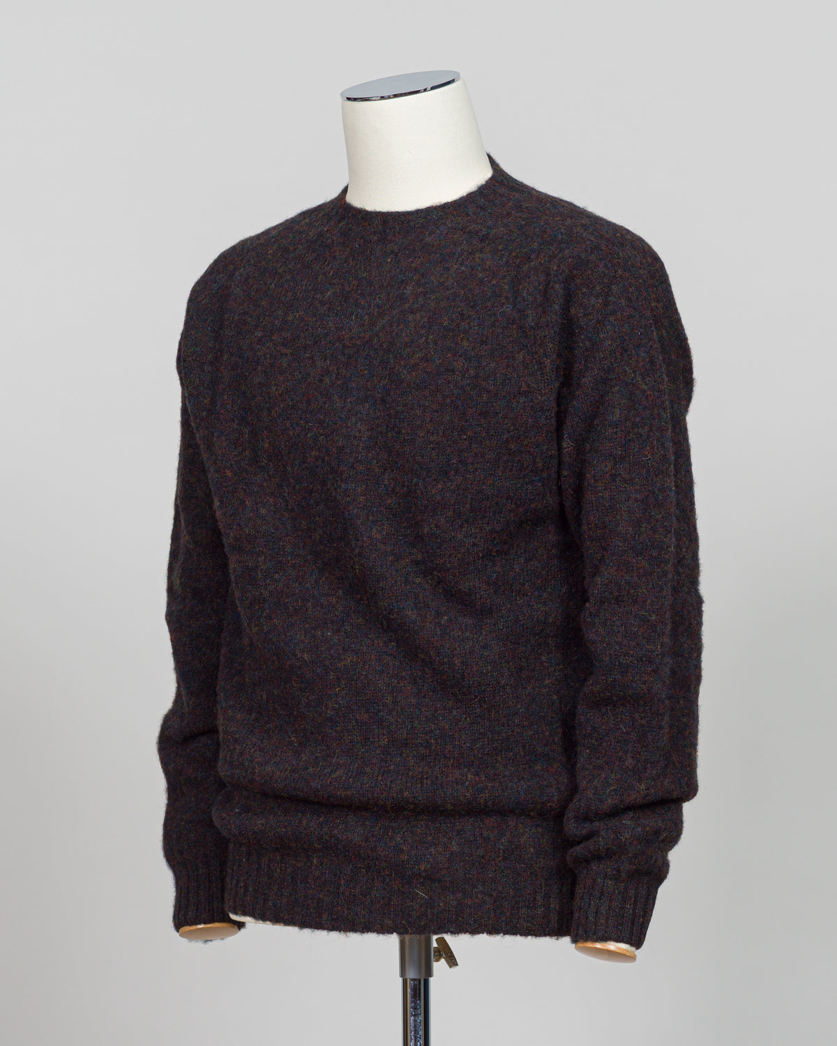 Harley of Scotland's iconic shaggy crew neck sweater in volcano. Hand-knitted using traditional Scottish techniques, this piece features a distinctive textured surface that catches light beautifully while delivering exceptional softness against the skin. The relaxed crew neck silhouette works seamlessly as a standalone layer or under tailored blazers for refined versatility.

Premium wool construction provides natural warmth and breathability across seasons. The generous shag pile creates visual depth and t