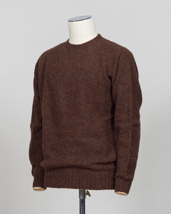 Harley of Scotland's iconic shaggy crew neck sweater in marron. Hand-knitted using traditional Scottish techniques, this piece features a distinctive textured surface that catches light beautifully while delivering exceptional softness against the skin. The relaxed crew neck silhouette works seamlessly as a standalone layer or under tailored blazers for refined versatility.

Premium wool construction provides natural warmth and breathability across seasons. The generous shag pile creates visual depth and ta