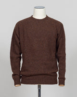 Harley of Scotland's iconic shaggy crew neck sweater in marron. Hand-knitted using traditional Scottish techniques, this piece features a distinctive textured surface that catches light beautifully while delivering exceptional softness against the skin. The relaxed crew neck silhouette works seamlessly as a standalone layer or under tailored blazers for refined versatility.

Premium wool construction provides natural warmth and breathability across seasons. The generous shag pile creates visual depth and ta