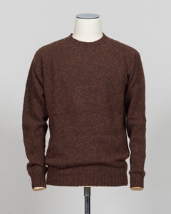 Harley of Scotland's iconic shaggy crew neck sweater in marron. Hand-knitted using traditional Scottish techniques, this piece features a distinctive textured surface that catches light beautifully while delivering exceptional softness against the skin. The relaxed crew neck silhouette works seamlessly as a standalone layer or under tailored blazers for refined versatility.

Premium wool construction provides natural warmth and breathability across seasons. The generous shag pile creates visual depth and ta