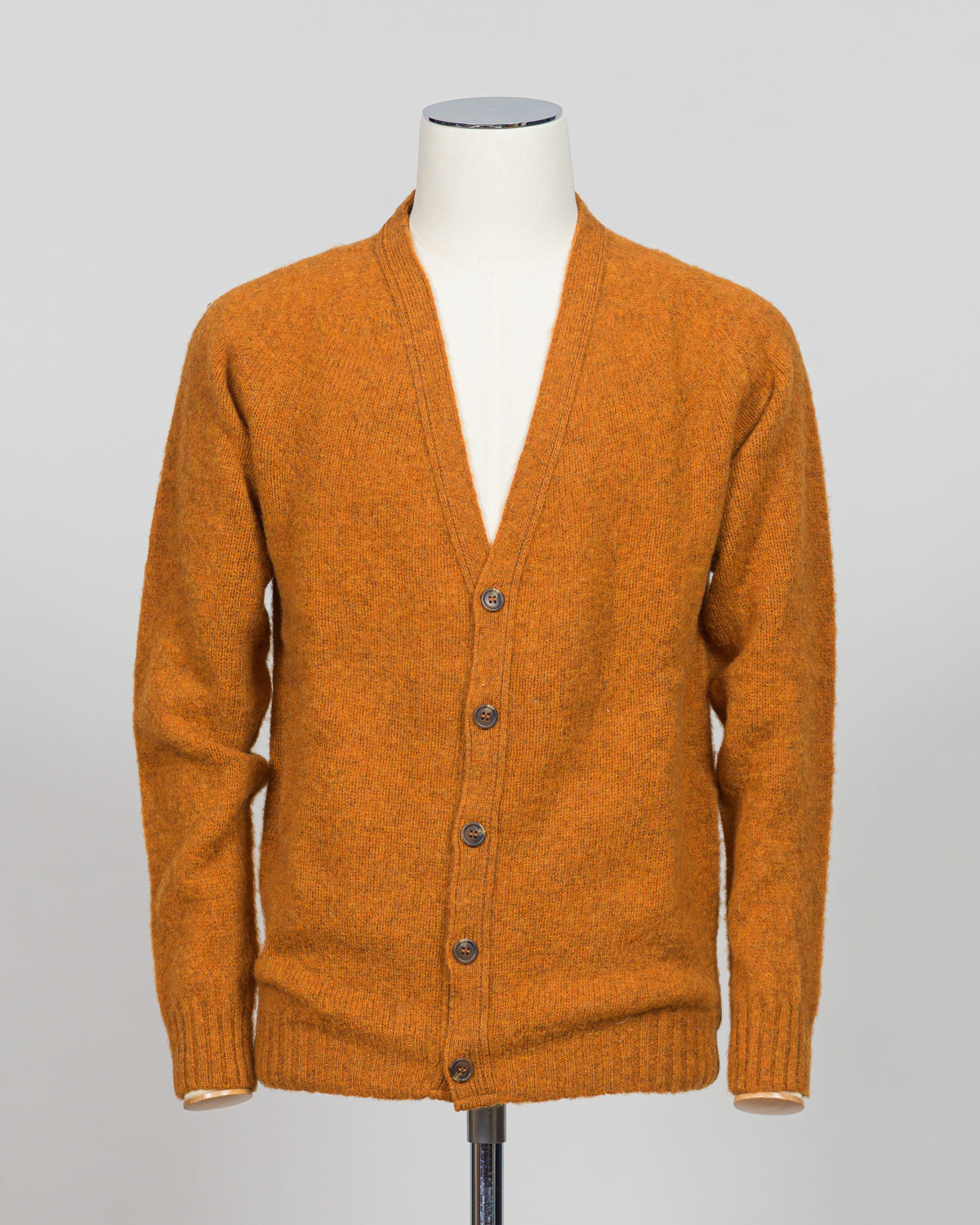 A timeless shaggy cardigan from Harley of Scotland, crafted in luxurious amber wool. This investment piece features a distinctive textured knit that adds depth and character to any wardrobe. Perfect for layering over shirts or wearing as a standalone statement, it delivers the rugged sophistication that defines Scottish knitwear heritage. The relaxed fit and substantial construction ensure years of wear, making it an essential addition to a refined menswear collection.