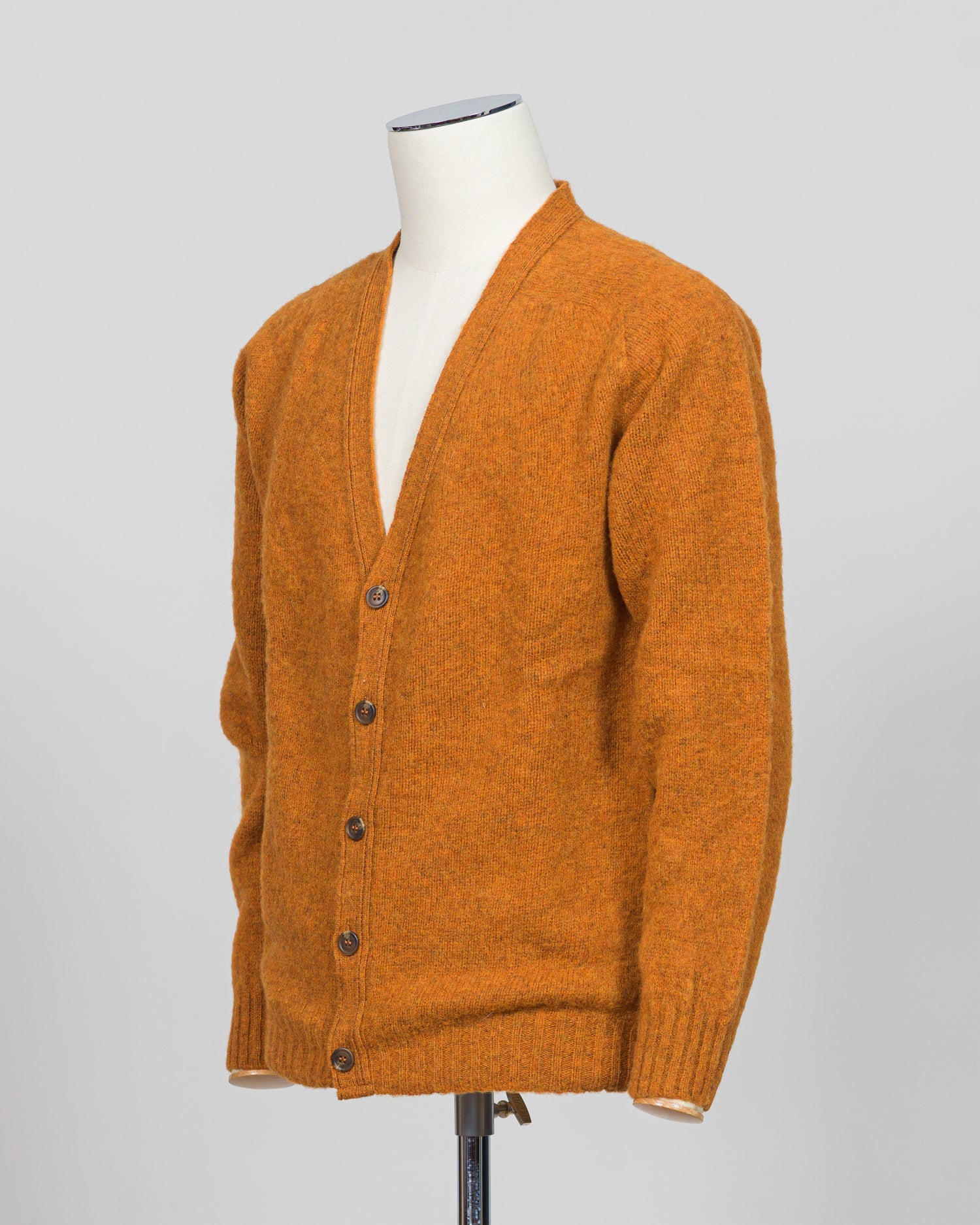 A timeless shaggy cardigan from Harley of Scotland, crafted in luxurious amber wool. This investment piece features a distinctive textured knit that adds depth and character to any wardrobe. Perfect for layering over shirts or wearing as a standalone statement, it delivers the rugged sophistication that defines Scottish knitwear heritage. The relaxed fit and substantial construction ensure years of wear, making it an essential addition to a refined menswear collection.