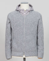 A relaxed layering essential in sumptuous bouclé knit. Gran Sasso's full-zip hoodie bridges the gap between structured knitwear and effortless comfort—perfect for weekend dressing or layering over basics. The light grey tone pairs seamlessly with tailored trousers or casual denim. Italian craftsmanship meets approachable luxury in a piece that works as hard as you do. Gran Sasso Full-Zip Bouclé Hoodie / Light Grey