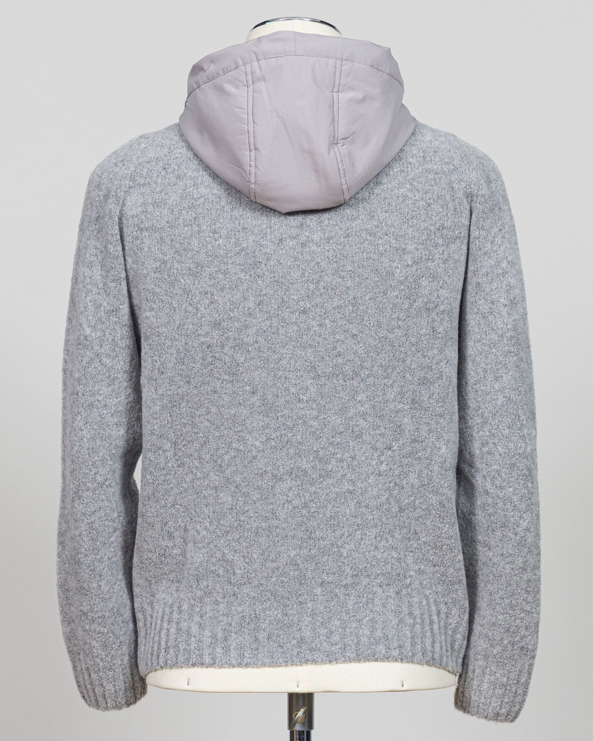 A relaxed layering essential in sumptuous bouclé knit. Gran Sasso's full-zip hoodie bridges the gap between structured knitwear and effortless comfort—perfect for weekend dressing or layering over basics. The light grey tone pairs seamlessly with tailored trousers or casual denim. Italian craftsmanship meets approachable luxury in a piece that works as hard as you do. Gran Sasso Full-Zip Bouclé Hoodie / Light Grey