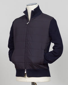A dark navy blue quilted puffer vest jacket with ribbed knit collar, cuffs, and hem, displayed on a cream mannequin torso against a light gray background. talian wool craftsmanship meets contemporary tailoring in this Gran Sasso sartorial padded jacket. Structured in premium wool with subtle padding for refined warmth, it pairs effortlessly with business wear or elevated casual styling. Gran Sasso Sartorial Padded &nbsp;Wool Jacket / Navy