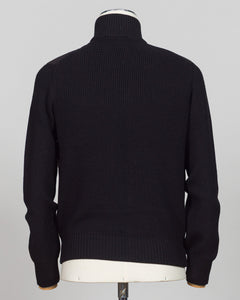 A black ribbed knit turtleneck sweater displayed on a white mannequin torso, viewed from the back against a light gray background. Italian wool craftsmanship meets contemporary tailoring in this Gran Sasso sartorial padded jacket. Structured in premium wool with subtle padding for refined warmth, it pairs effortlessly with business wear or elevated casual styling. Gran Sasso Sartorial Padded &nbsp;Wool Jacket / Black