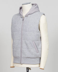 Lightweight insulation meets refined elegance in this Gran Sasso padded hooded vest. The soft light grey colourway pairs seamlessly with layered knitwear or worn solo over shirts for versatile warmth. Italian craftsmanship ensures a tailored silhouette that bridges casual and smart-casual dressing. Essential for the discerning wardrobe. Gran Sasso Padded Hooded Vest / Light Grey