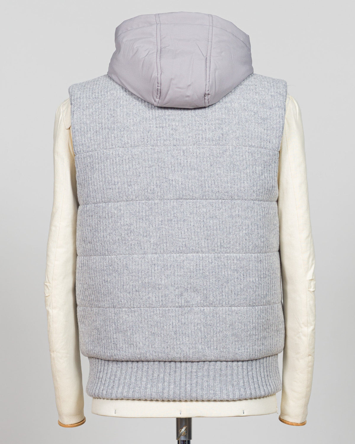 Lightweight insulation meets refined elegance in this Gran Sasso padded hooded vest. The soft light grey colourway pairs seamlessly with layered knitwear or worn solo over shirts for versatile warmth. Italian craftsmanship ensures a tailored silhouette that bridges casual and smart-casual dressing. Essential for the discerning wardrobe. Gran Sasso Padded Hooded Vest / Light Grey