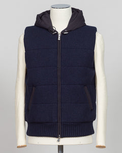 Lightweight padded hooded vest in deep navy. Crafted by Gran Sasso, this essential layer offers sophisticated warmth without bulk. Perfect layered over knitwear or worn standalone for refined, modern styling. Premium construction ensures lasting comfort and durability. Gran Sasso Padded Hooded Vest / Navy