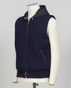 Lightweight padded hooded vest in deep navy. Crafted by Gran Sasso, this essential layer offers sophisticated warmth without bulk. Perfect layered over knitwear or worn standalone for refined, modern styling. Premium construction ensures lasting comfort and durability. Gran Sasso Padded Hooded Vest / Navy