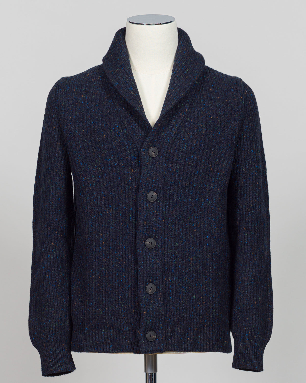 A dark navy blue ribbed knit cardigan sweater with a shawl collar and front buttons, displayed on a white mannequin torso against a light gray background.