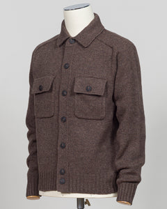 A brown knit button-front cardigan sweater displayed on a mannequin torso against a light gray studio background. The cardigan has a collar, long sleeves, ribbed cuffs and hem, and two large chest flap pockets with dark buttons.