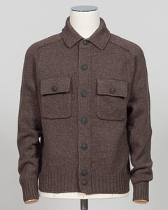 A brown knit button-front cardigan sweater with a pointed collar and two flap chest pockets, displayed on a mannequin torso against a light gray studio background.