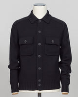A black knit button-up cardigan sweater with a collar and two chest flap pockets, displayed on a mannequin torso against a light gray background.