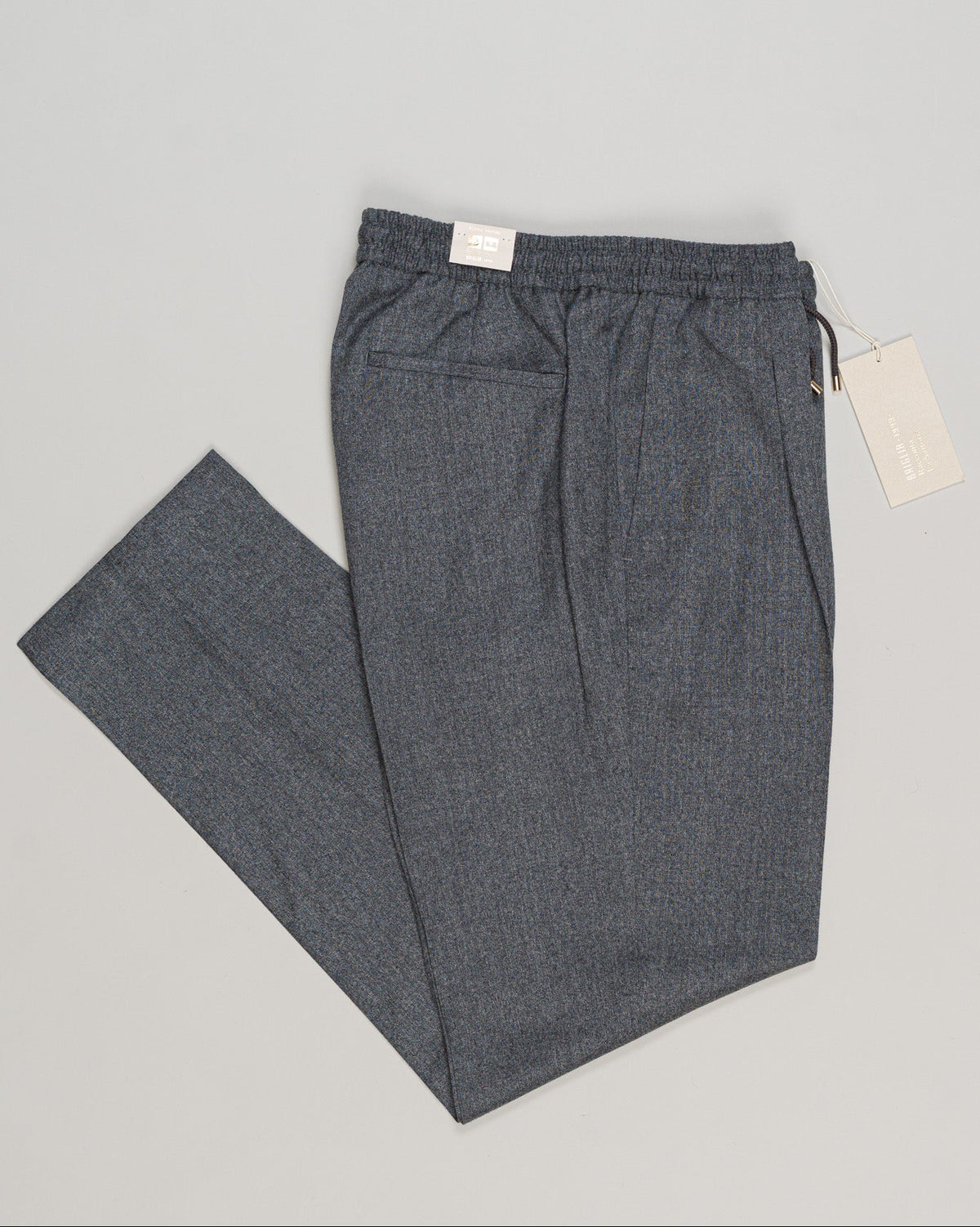 Italian tailoring meets everyday ease. These drawstring flannel trousers from Briglia offer refined comfort in a soft grey that pairs effortlessly with knitwear and casual blazers. The relaxed silhouette and quality construction deliver a polished look without formality—ideal for layering and versatile styling. Briglia Drawstring Flannel Trousers / Grey