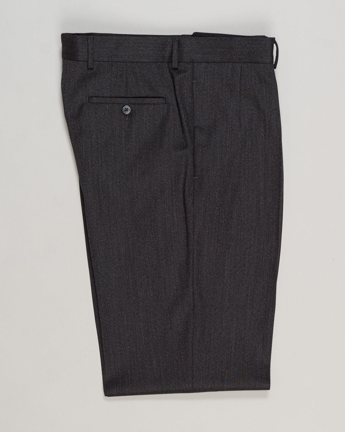 Tailored Caruso trousers in a refined covert weave, featuring elegant knife pleats that define the silhouette. Dark grey wool offers versatile sophistication for both formal occasions and elevated everyday wear. The structured construction and precise tailoring ensure a graceful drape and enduring quality characteristic of Italian craftsmanship. Caruso Pleated Covert Wool Trousers / Dark Grey