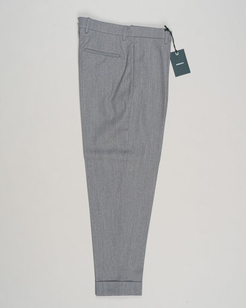 Crafted from a refined blend of wool and cotton, these Berwich trousers exemplify Italian tailoring at its finest. The long-staple gabardine weave delivers a subtle lustre and exceptional drape, while the balanced fibre composition ensures breathability and durability across seasons.

The versatile grey tone pairs seamlessly with sport coats, knitwear, and tailored jackets. Clean lines and a measured cut reflect contemporary menswear proportions without compromise on classic elegance.

A foundation piece fo