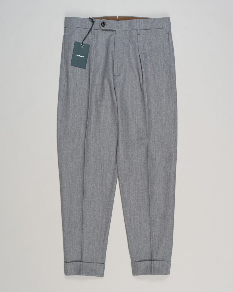 Crafted from a refined blend of wool and cotton, these Berwich trousers exemplify Italian tailoring at its finest. The long-staple gabardine weave delivers a subtle lustre and exceptional drape, while the balanced fibre composition ensures breathability and durability across seasons.

The versatile grey tone pairs seamlessly with sport coats, knitwear, and tailored jackets. Clean lines and a measured cut reflect contemporary menswear proportions without compromise on classic elegance.

A foundation piece fo