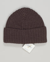 Refined merino wool beanie in a subtle ribbed knit. The natural temperature-regulating properties of merino keep you comfortable in shifting seasons, while the timeless brown colorway pairs effortlessly with any wardrobe. A minimal essential for everyday wear. &nbsp;Calimar Ribbed Merino Beanie / Brown