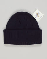 A refined wool watch cap in deep navy, crafted for understated elegance and everyday warmth. The Calimar combines Italian knitwear tradition with a timeless silhouette—structured yet relaxed, versatile enough for casual layering or as a standalone statement piece. Premium wool construction ensures durability and natural temperature regulation. An essential addition to any curated menswear wardrobe. Calimar Wool Watch Cap / Navy