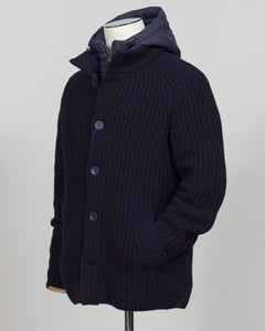 Herno's lined cardigan in navy combines Italian craftsmanship with refined minimalism. Constructed from premium wool with a structured silhouette, the interior lining ensures comfort through layering or as a standalone piece. The clean lines and versatile navy tone work seamlessly with tailored trousers or casual wear, making it an essential addition to a modern menswear wardrobe. Perfect for transitional seasons or layering year-round.