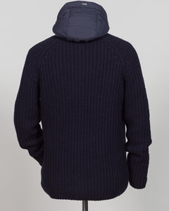 Herno's lined cardigan in navy combines Italian craftsmanship with refined minimalism. Constructed from premium wool with a structured silhouette, the interior lining ensures comfort through layering or as a standalone piece. The clean lines and versatile navy tone work seamlessly with tailored trousers or casual wear, making it an essential addition to a modern menswear wardrobe. Perfect for transitional seasons or layering year-round.
