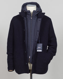 Herno's lined cardigan in navy combines Italian craftsmanship with refined minimalism. Constructed from premium wool with a structured silhouette, the interior lining ensures comfort through layering or as a standalone piece. The clean lines and versatile navy tone work seamlessly with tailored trousers or casual wear, making it an essential addition to a modern menswear wardrobe. Perfect for transitional seasons or layering year-round.