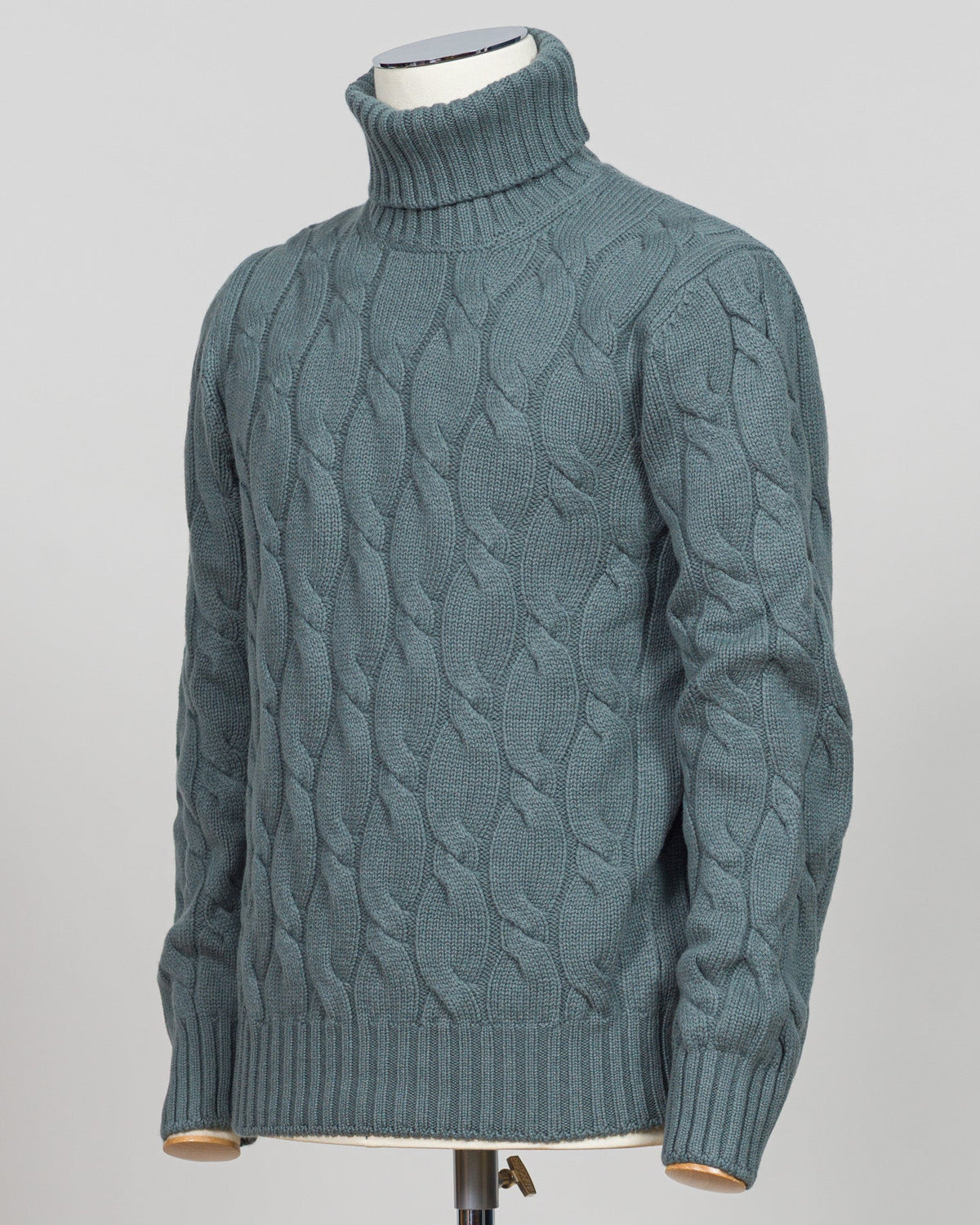 A refined cable-knit roll neck in soft sage green. Crafted with classic construction and versatile color, it pairs effortlessly with tailored trousers or layered beneath a suit jacket. Essential luxury knitwear for the discerning wardrobe. Gran Sasso Cable Roll Neck Knit / Sage Green