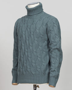 A refined cable-knit roll neck in soft sage green. Crafted with classic construction and versatile color, it pairs effortlessly with tailored trousers or layered beneath a suit jacket. Essential luxury knitwear for the discerning wardrobe. Gran Sasso Cable Roll Neck Knit / Sage Green