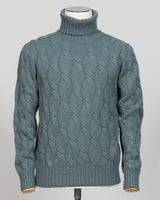 A refined cable-knit roll neck in soft sage green. Crafted with classic construction and versatile color, it pairs effortlessly with tailored trousers or layered beneath a suit jacket. Essential luxury knitwear for the discerning wardrobe. Gran Sasso Cable Roll Neck Knit / Sage Green