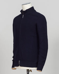 A dark navy blue ribbed knit zip-up sweater displayed on a white mannequin torso against a light gray  Water-repellent merino wool hoodie in navy. Engineered for layering and everyday wear, this Gran Sasso piece combines breathable warmth with practical weather resistance. Perfect for transitional seasons and active lifestyles. Gran Sasso Rain Wool Hoodie / Navybackground.