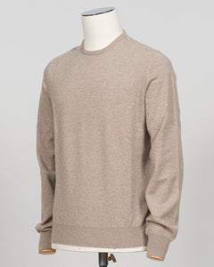A light beige crewneck sweater displayed on a white mannequin torso against a neutral light gray background.  Gran Sasso's timeless cashmere crew neck in soft beige epitomizes understated luxury. Crafted from 100% pure cashmere with a vintage-washed finish that develops character with wear, this Italian-made essential features a relaxed fashion fit, ribbed detailing at the hem and cuffs, and a refined crew neckline. An investment piece that anchors any wardrobe. Gran Sasso Cashmere Crew Neck / Beige