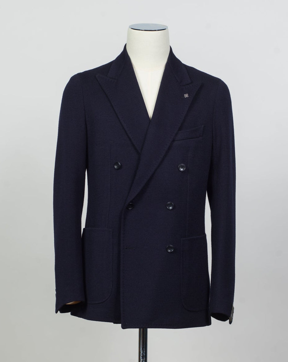 Composition: 40% Polyester 30% Virgin wool 30% Acrylic
Lining: 100% Cupro
Modello: Monte Carlo / 1SHJ20K
Color: Navy / B3459
Unconstructed shoulder
Unlined
6 Buttons
Peak lapel
Patch pockets
Side vents
Made in Martina Franca, Italy Tagliatore Double-Breasted Jersey Jacket / Navy