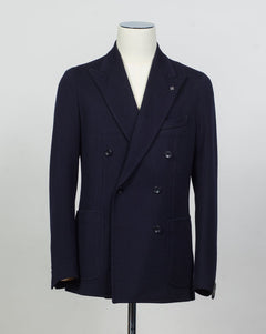 Composition: 40% Polyester 30% Virgin wool 30% Acrylic
Lining: 100% Cupro
Modello: Monte Carlo / 1SHJ20K
Color: Navy / B3459
Unconstructed shoulder
Unlined
6 Buttons
Peak lapel
Patch pockets
Side vents
Made in Martina Franca, Italy Tagliatore Double-Breasted Jersey Jacket / Navy