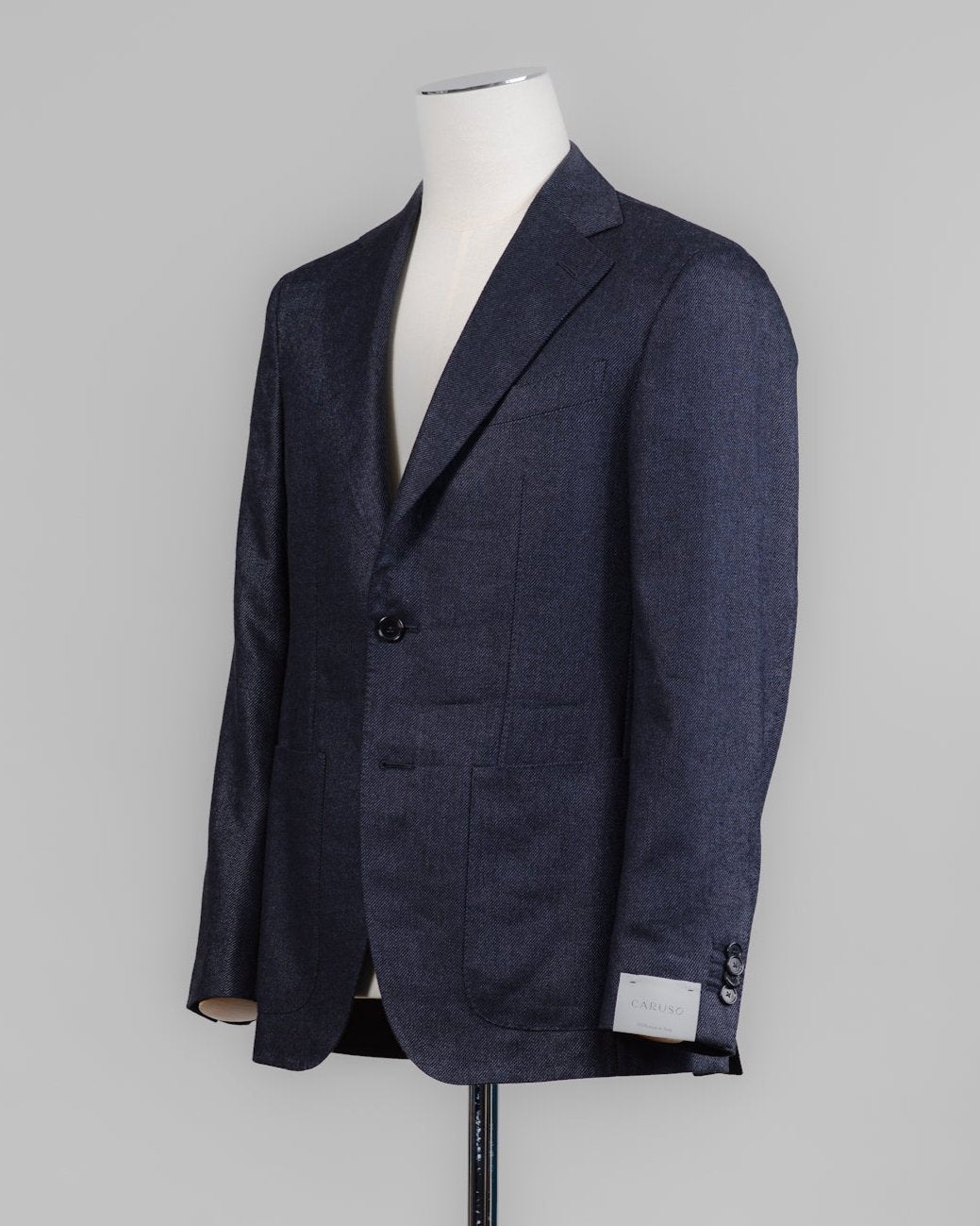 Caruso blazer impeccably tailored in Soragna, Parma, Italy.
Stunning lightness and ease of movement without losing the classic tailored elegance. These are some of the ingredients that make Italian tailoring world famous and you can find it all in Caruso garments.&nbsp;

Beautiful handmade detailing and naturally with a&nbsp;full canvas structure&nbsp;inside.

Full canvas
Fully lined&nbsp;
Unconstructed shoulder
Model: Aida
Composition: 54% Wool, 43% Linen, 3% Cashmere
Color: 0120 / Navy Caruso Wool Blend J