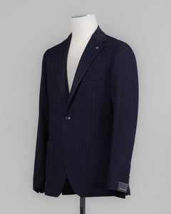 Composition: 40% Polyester 30% Virgin Wool 30% Acrylic
Modello: Monte Carlo / 1SMJ22K
Color: Navy / B3343
Unconstructed shoulder
Unlined
2 Buttons
Notch lapel
Patch pockets
Side vents
Made in Martina Franca, Italy Tagliatore Jersey Knit Jacket / Navy
