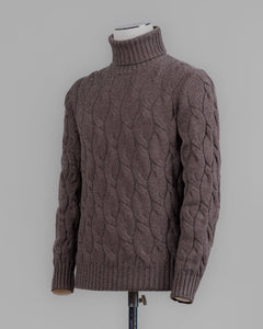 Classic version of a heavy roll neck with a beautiful knitted cable pattern. Warm and comfortable for the cold season.

Article: 13115/19659
Color: 184 / Brown
Composition: 80% Virgin Wool 10% Cashmere 10% Viscose

Made in Italy Gran Sasso Cable Knit Roll Neck / Brown