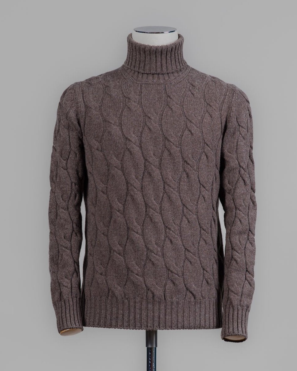 Classic version of a heavy roll neck with a beautiful knitted cable pattern. Warm and comfortable for the cold season.

Article: 13115/19659
Color: 184 / Brown
Composition: 80% Virgin Wool 10% Cashmere 10% Viscose

Made in Italy Gran Sasso Cable Knit Roll Neck / Brown