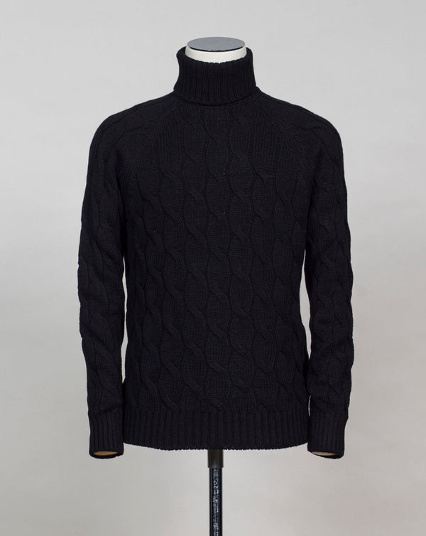 Gran Sasso cable knit roll neck made of special 3-ply Air Wool quality. The special feature of this garment is the yarn that holds microscopic air bubbles between the fibers, making it at the same time warm and light.  Art. 13117/22622 Col. 099 Black 100% Wool Made in Italy 