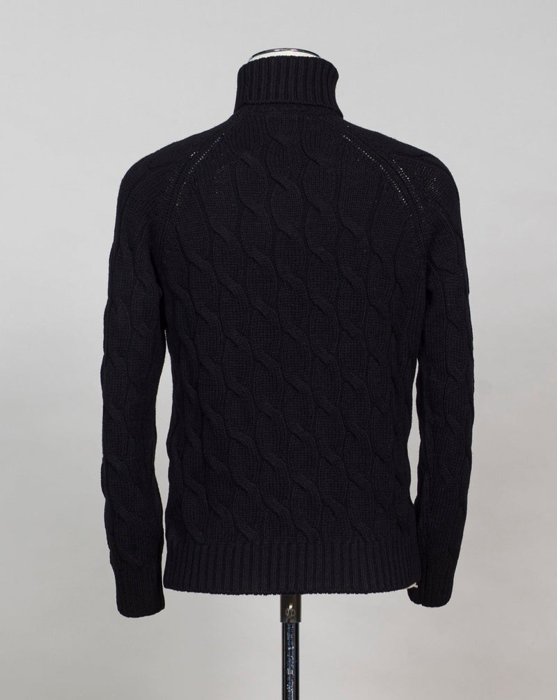 Gran Sasso cable knit roll neck made of special 3-ply Air Wool quality. The special feature of this garment is the yarn that holds microscopic air bubbles between the fibers, making it at the same time warm and light.  Art. 13117/22622 Col. 099 Black 100% Wool Made in Italy 