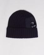 C.P. Lens detailing Zippered small pocket detailing Art. 15CMAC300A 005509A Col 888 / Total Eclipse / Navy Blue C.P. Company Extra Fine Merino Wool Side Lens Beanie / Total Eclipse