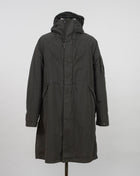 Military inspired long parka coat. 50 Fili -fabric is a nylon/cotton mix derived from American field parkas. The polyurethane coating makes it ideal for hardwearing outerwear. Garment dyed for an increased chromatic depth and intensity throughout. Article: 15CMOW276A 005966G Color: 670 / Olive Night External fabric: 75% Cotton, 25% Polyamide / Nylon Lining: 100% Cotton Coating: 100% Polyurethan 