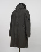 Military inspired long parka coat. 50 Fili -fabric is a nylon/cotton mix derived from American field parkas. The polyurethane coating makes it ideal for hardwearing outerwear. Garment dyed for an increased chromatic depth and intensity throughout. Article: 15CMOW276A 005966G Color: 670 / Olive Night External fabric: 75% Cotton, 25% Polyamide / Nylon Lining: 100% Cotton Coating: 100% Polyurethan 