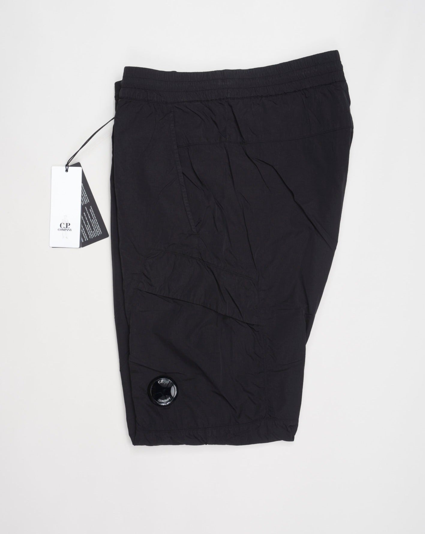 Multifilament fabric in Recycled nylon yarn Regular fit Drawstring waist Cuffed leg opening Single cargo pocket on left Leg Lens detail Garment dyed Article: 15CMPA247A005904G Color: Black / 999