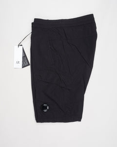 Multifilament fabric in Recycled nylon yarn Regular fit Drawstring waist Cuffed leg opening Single cargo pocket on left Leg Lens detail Garment dyed Article: 15CMPA247A005904G Color: Black / 999