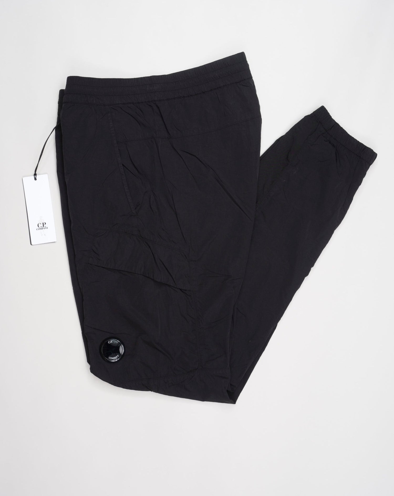 Multifilament fabric in Recycled nylon yarn Regular fit Drawstring waist Cuffed leg opening Single cargo pocket on left Leg Lens detail Garment dyed Article: 15CMPA247A005904G Color: Black / 999