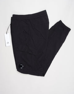 Multifilament fabric in Recycled nylon yarn Regular fit Drawstring waist Cuffed leg opening Single cargo pocket on left Leg Lens detail Garment dyed Article: 15CMPA247A005904G Color: Black / 999