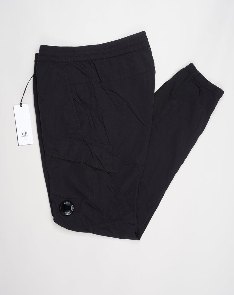 Multifilament fabric in Recycled nylon yarn Regular fit Drawstring waist Cuffed leg opening Single cargo pocket on left Leg Lens detail Garment dyed Article: 15CMPA247A005904G Color: Black / 999
